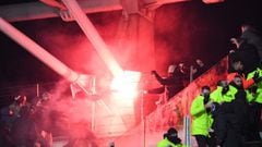 Supporters hold a flare during the French Cup round of 64 football match between Paris FC and Olympique Lyonnais (OL) at the Charlety stadium in Paris, on December 17, 2021. - The match was interrupted due to incidents in the stands. At half-time, several