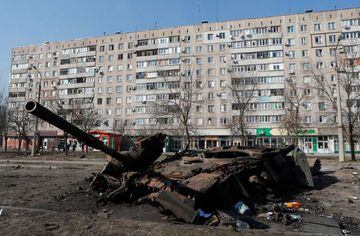 A tank destroyed in fighting during Ukraine-Russia conflict is seen in front of a residential building, in the besieged southern port of Mariupol, Ukraine March 23, 2022