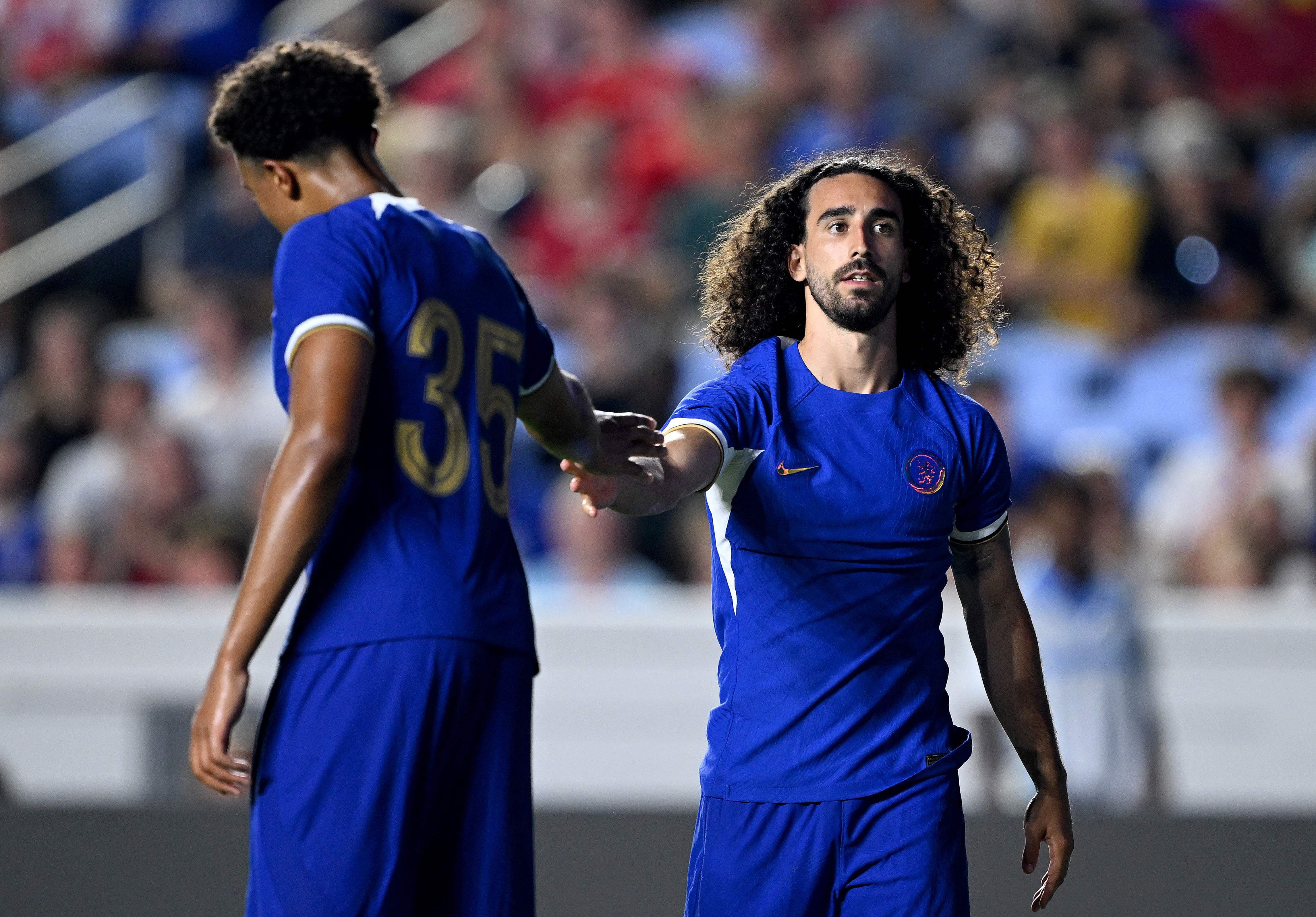CHAPEL HILL, NORTH CAROLINA - JULY 19: Marc Cucurella #32 high-fives Bashir Humphreys #35 of Chelsea FC during the first half of a pre-season friendly match against Wrexham AFC at Kenan Stadium on July 19, 2023 in Chapel Hill, North Carolina.   Grant Halverson/Getty Images/AFP (Photo by GRANT HALVERSON / GETTY IMAGES NORTH AMERICA / Getty Images via AFP)