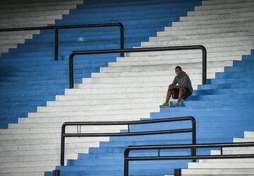 A ballboy waits in the empty stands of Presidente Peron Stadium prior to a Group F match between Racing Club and Alianza Lima as part of Copa CONMEBOL Libertadores 2020