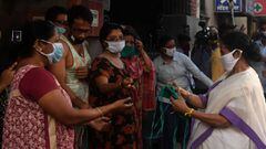 West Bengal Chief Minister Mamata Banerjee distributes facemasks during her visit to a ration shop in Kolkata on  April 17, 2020.