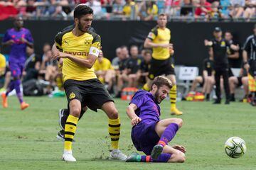 Liverpool's Adam Lallana (R) vies for the ball with Borussia Dortmund's Nuri Sahin (L) during the 2018 International Champions Cup at Bank of America Stadium in Charlotte, North Carolina, on July 22, 2018.  / AFP PHOTO / JIM WATSON