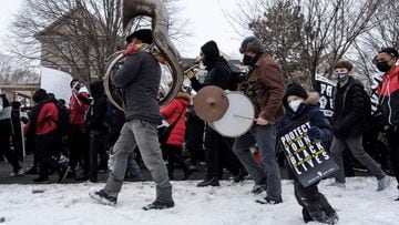 A child joins students during a state-wide walkout demanding justice for Amir Locke a Black man who was shot and killed by Minneapolis police, in St. Paul, Minnesota.