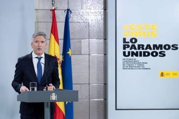 This handout picture made available by the Moncloa Palace shows Spain's Minister of Interior Fernando Grande-Marlaska giving a press conference on March 30, 2020 in Madrid. - Spain confirmed another 812 deaths in 24 hours from the coronavirus on Monday, b