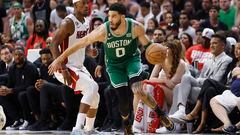 Boston Celtics forward Jayson Tatum (R) drives the ball past Miami Heat forward Jimmy Butler (L)