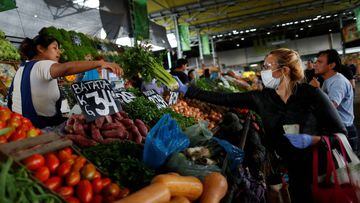 A woman shops while wearing a face mask as a preventive measure against the coronavirus disease (COVID-19) spread, at a wholesale food market Mercado Central (central market), in La Matanza, on the outskirts of Buenos Aires, Argentina April 1, 2020. REUTERS/Agustin Marcarian