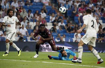 Milan's Franck Kessie (second left) challenges for the ball with Real goalkeeper Keylor Navas (second right).