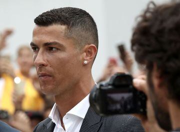 Portuguese footballer Cristiano Ronaldo walks out the Juventus medical center at the Alliance stadium in Turin on July 16, 2018 to greet supporters.