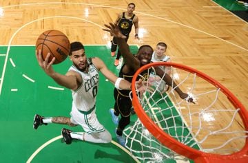 The Boston Celtics' Jayson Tatum (0) attempts a basket in front of Golden State Warriors forward Draymond Green (23) in Game 3 at TD Garden on Wednesday.