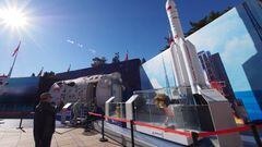 Visitors view a model of the Long March 5 rocket during the Achievement exhibition themed "Striving for a New Era" at the Beijing Exhibition Center in Beijing, China, Nov 4, 2022.