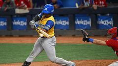 Colombia's Vaqueros de Monteria catcher Daniel Vellojin (L) hits the ball during the Caribbean Series game against Dominican Republic's Tigres de Licey at the Monumental Simon Bolivar stadium in Caracas on February 7, 2023. (Photo by Federico PARRA / AFP)