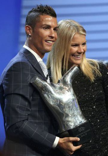 Real Madrid's Cristiano Ronaldo of Portugal (L) and Olympique Lyon's Ada Hegerberg of Norway react as after they received the Best Player UEFA 2015/16 Award during the draw ceremony for the 2016/2017 Champions League Cup soccer competition at Monaco's Gri