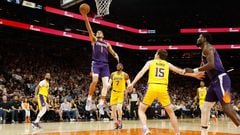 PHOENIX, ARIZONA - APRIL 05: Devin Booker #1 of the Phoenix Suns lays up a shot against Austin Reaves #15 of the Los Angeles Lakers during the second half of the NBA game at Footprint Center on April 05, 2022 in Phoenix, Arizona. The Suns defeated the Lakers 121-110.