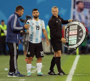 Agüero (centre) gets ready to come on.