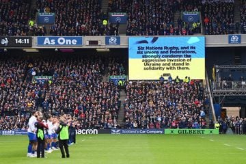 EDINBURGH, SCOTLAND - FEBRUARY 26: Players, staff and spectators applaud as a message is shown on the LED board expressing solidarity with Ukraine prior to the Six Nations Rugby match between Scotland and France at BT Murrayfield Stadium on February 26, 2