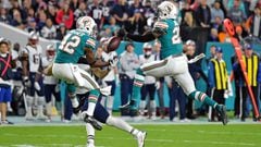 Dec 11, 2017; Miami Gardens, FL, USA; Miami Dolphins free safety Reshad Jones (20) and defensive back Alterraun Verner (42) break up a pass to New England Patriots wide receiver Chris Hogan (15) during the second half at Hard Rock Stadium. Mandatory Credit: Jasen Vinlove-USA TODAY Sports