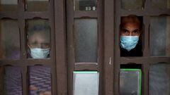 LIMA, PERU - JUNE 25: Two coronavirus infected patients look out from the window while in isolation at Victor Larco Herrera Mental Hospital on June 25, 2020 in Lima, Peru. Tests carried at the largest mental hospital in Peru confirmed that 162 of of 342 patients and 121 workers were infected with COVID-19. Authorities informed 95 patients have already recovered. Peru is the second worst-hit country in Latin America with 264.689 positive cases, only after Brazil. (Photo by Raul Sifuentes/Getty Images)
