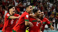 Morocco's defender #02 Achraf Hakimi (2nd R) celebrates with teammates after converting the last penalty during the penalty shoot-out to win the Qatar 2022 World Cup round of 16 football match between Morocco and Spain at the Education City Stadium in Al-Rayyan, west of Doha on December 6, 2022. (Photo by JAVIER SORIANO / AFP)