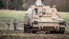 A tank and soldiers are seen during the live firing exercise DYNAMIC FRONT 23 at Grafenwoehr training site in Grafenwoehr, Germany, March 28, 2023. REUTERS/Leonhard Simon