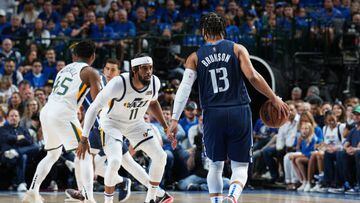 DALLAS, TX - APRIL 16:  Mike Conley #11 of the Utah Jazz plays defense on Jalen Brunson #13 of the Dallas Mavericks during Round 1 Game 1 of the 2022 NBA Playoffs on April 16, 2022 at the American Airlines Center in Dallas, Texas. NOTE TO USER: User expressly acknowledges and agrees that, by downloading and or using this photograph, User is consenting to the terms and conditions of the Getty Images License Agreement. Mandatory Copyright Notice: Copyright 2022 NBAE (Photo by Glenn James/NBAE via Getty Images)