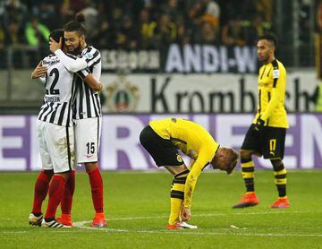 Frankfurt players Timothy Chandler and Michael Hector celebrate next to Dortmund players Pierre-Emerick Aubameyang and Marco Reus.