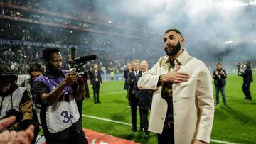 Real Madrid's French forward Karim Benzema gestures to fans during the presentation of his Ballon d'Or trophy at half time of the French L1 football match between Olympique Lyonnais (OL) and OGC Nice at The Groupama Stadium in Decines-Charpieu, central-eastern France, on November 11, 2022. (Photo by OLIVIER CHASSIGNOLE / AFP) (Photo by OLIVIER CHASSIGNOLE/AFP via Getty Images)