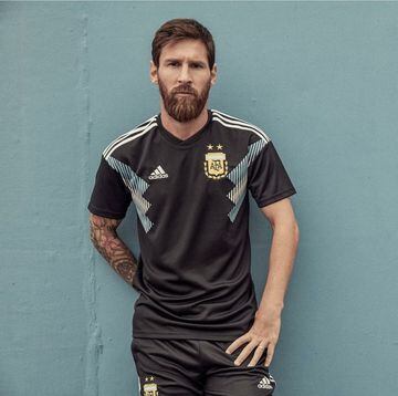 Lionel Messi tries Argentina's new away shirt for size.