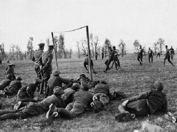 Soldiers down weapons to play a game of football in WWI.