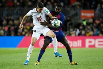 Granada's Carlos Fernandez (L) vies with Barcelona's French defender Samuel Umtiti.