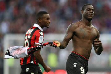 Balotelli (right) celebrates after scoring Nice's winner - he was subsequently booked for taking his shirt off.