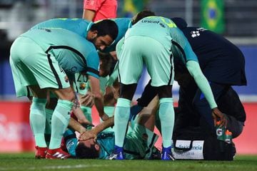 Busquets receives medical treatment after being injured by Escalante's challenge.