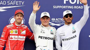 SPIELBERG, AUSTRIA - JULY 08: Top three qualifiers Valtteri Bottas of Finland and Mercedes GP, Sebastian Vettel of Germany and Ferrari and Lewis Hamilton of Great Britain and Mercedes GP pose for a photo in parc ferme during qualifying for the Formula One Grand Prix of Austria at Red Bull Ring on July 8, 2017 in Spielberg, Austria.  (Photo by Mark Thompson/Getty Images)