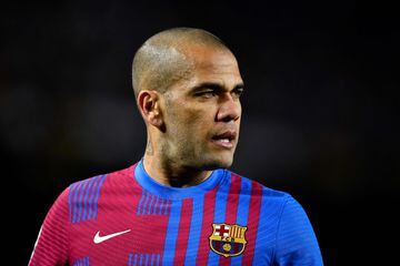 (FILES) In this file photo taken on February 27, 2022 Barcelona's Brazilian defender Dani Alves looks on during the Spanish league football match between FC Barcelona and Athletic Club Bilbao at the Camp Nou stadium in Barcelona. - Former Brazil defender Dani Alves was taken into custody on January 20, 2023 in Spain over allegations that he sexually assualted a woman at a Barcelona nightclub in December, police said. The 39-year-old player was summoned to a Barcelona police station where he was "taken into custody" and will now be questioned by a judge, said a spokesman for Catalonia's regional police force, the Mossos d'Esquadra. (Photo by Pau BARRENA / AFP)