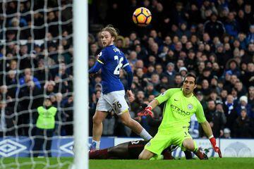 Tom Davies of Everton lifts the ball over goalkeeper Claudio Bravo of Manchester City