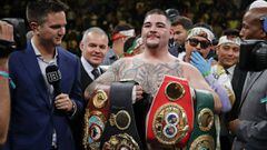 FILE - In this Saturday, June 1, 2019, file photo, Andy Ruiz poses with championship belts after defeating Anthony Joshua to capture the unified world heavyweight title. Ruiz has become a folk hero overnight among people of Mexican ancestry in the United States. (AP Photo/Frank Franklin II, File)