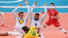 France&#039;s Barthelemy Chinenyeze (L) and Earvin Ngapeth (R) block a shot by Brazil&#039;s Lucas Saatkamp (C) in the men&#039;s preliminary round pool B volleyball match between Brazil and France during the Tokyo 2020 Olympic Games at Ariake Arena in To