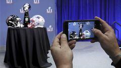 FILE - In this Wednesday, Feb. 1, 2017, file photo, an attendee snaps a photo of the Vince Lombardi Trophy and team helmets during NFL Commissioner Roger Goodell's news conference for Super Bowl 51, in Houston. The Atlanta Falcons will face the New England Patriots in the Super Bowl on Sunday. Fox will show the game online for free, but you’re out of luck on phones unless you’re a Verizon customer. (Curtis Compton/Atlanta Journal-Constitution via AP, File)