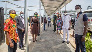 Staff of Arnergy Solar Limited and representatives of Lagos state government pose for a picture under the solar panels installed by Arnergy at an isolation centre for the coronavirus disease (COVID-19) patients in Lagos, Nigeria May 1, 2020. Picture taken