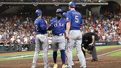 Houston (United States), 23/10/2023.- Texas Rangers Adolis Garcia (C) is greeted at home plate by Texas Rangers second baseman Marcus Semien (L), Texas Rangers Corey Seager (R), and Texas Rangers Leody Taveras (background) after hitting a grand slam (four run home run) off Houston Astros relief pitcher Ryne Stanek during the ninth inning of game six of the Major League Baseball (MLB) American League Championship Series playoffs between the Texas Rangers and Houston Astros at Minute Maid Park in Houston, Texas, USA, 22 October 2023. The League Championship Series is the best-of-seven games. The Astros lead the Rangers 3-2. (Liga de Campeones) EFE/EPA/KEN MURRAY
