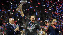Tom Brady of the New England Patriots holding the Vince Lombardi Trophy as Head coach Bill Belichick looks on