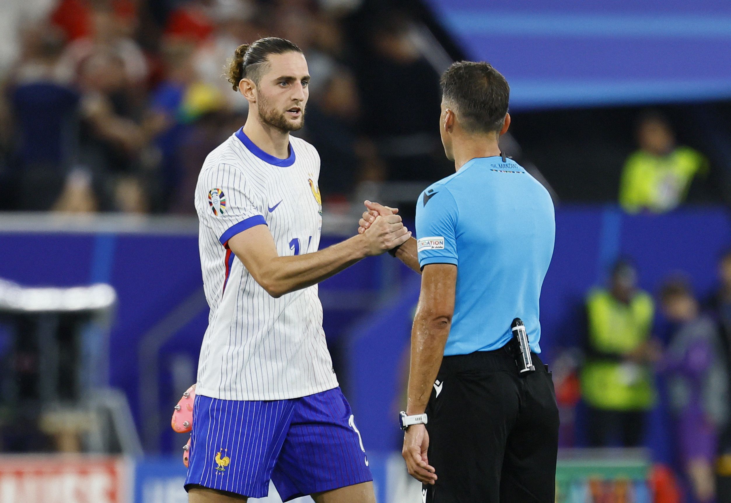 Soccer Football - Euro 2024 - Group D - Austria v France - Dusseldorf Arena, Dusseldorf, Germany - June 17, 2024 France's Adrien Rabiot shakes hands with referee Jesus Gil Manzano after the match REUTERS/Wolfgang Rattay