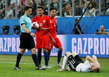Chile’s Gonzalo Jara (18) escaped with a yellow card after elbowing Germany's Timo Werner (on the ground) despite referee Milorad Mazic (left) asking for a video review of the incident.
