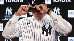 BRONX, NEW YORK - DECEMBER 21: Aaron Judge #99 of the New York Yankees puts on a jersey and hat during a press conference at Yankee Stadium on December 21, 2022 in Bronx, New York.   Dustin Satloff/Getty Images/AFP (Photo by Dustin Satloff / GETTY IMAGES NORTH AMERICA / Getty Images via AFP)