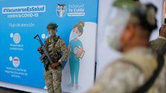 Army soldiers stand guard at a major vaccination centre in Lima where hundreds of Peruvian health workers receive their first dose against COVID-19 in Lima, on February 9, 2021. - Peru began its coronavirus immunisation program just two days after receiving 300,000 vaccine doses from state-owned Chinese company Sinopharm. Health care workers in Lima were the first to receive the vaccine on Tuesday morning. At least 298 doctors and 25 nurses have died in Peru due to the COVID-19 pandemic, among more than 20,000 health professionals who have contracted the virus, according to trade union organisations. (Photo by Luka GONZALES / AFP)