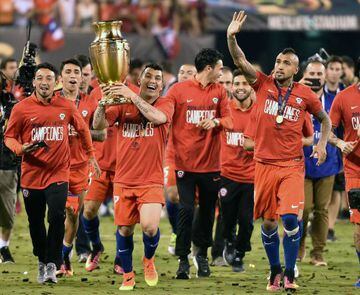 Chile's Gary Medel holds the Copa America Centenario trophy next to Arturo Vidal after an historic 2nd win in two years.