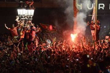 FC Barcelona supporters celebrate their team's league victory near Canaletas fountain on the Ramblas in Barcelona