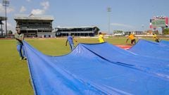 Grounds crew pull a tarp over the field August 22, 2016 as play is abandoned on day 5 of the 4th and final Test between West Indies and India at Queen&#039;s Park Oval in Port of Spain, Trinidad and Tobago. 