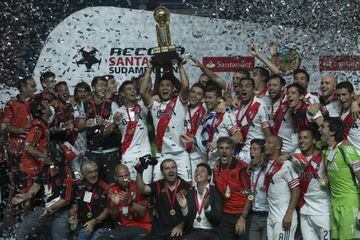 River Plate`s Teofilo Gutierrez, center, holds up the trophy as he celebrates with his teammates at the end of the Recopa Sudamericana