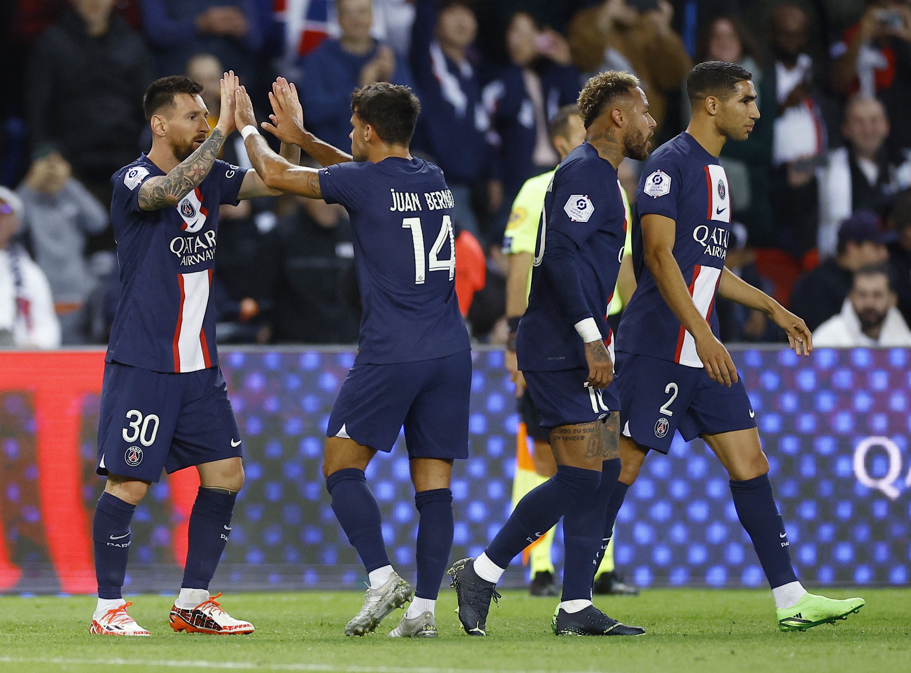 Soccer Football - Ligue 1 - Paris St Germain v OGC Nice - Parc des Princes, Paris, France - October 1, 2022 Paris St Germain's Lionel Messi celebrates scoring their first goal with Juan Bernat REUTERS/Christian Hartmann