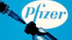  A vial and syringe are seen in front of a displayed Pfizer logo in this illustration taken January 11, 2021.